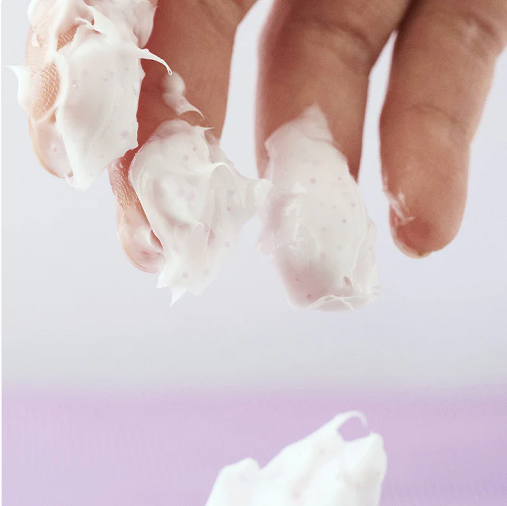 Applying Eqqualberry Bakuchiol Cream - capsules bursting on hands