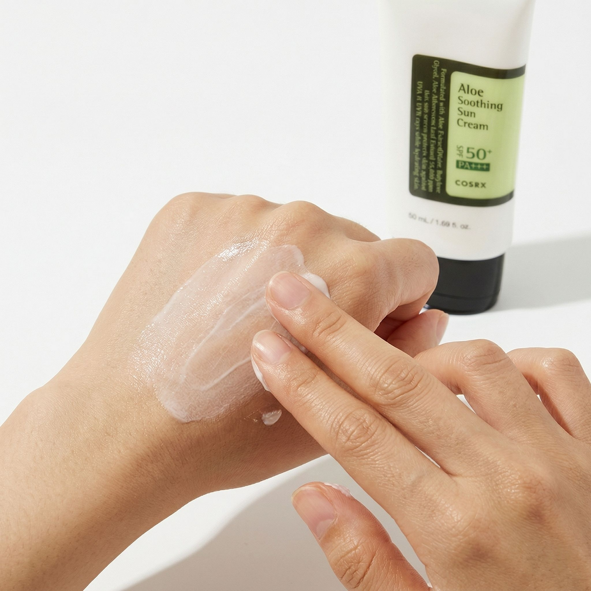 Applying COSRX Aloe Sun Cream on back of hand - lightweight no white cast
