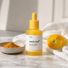 Medicube Kojic Acid Turmeric Niacinamide Serum on white marble vanity