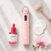 Medicube AGE-R Booster Pro Pink with skincare products on marble surface