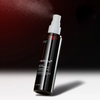 Spraying Medicube Red Body Peeling Shot on shoulder - 360 degree spray