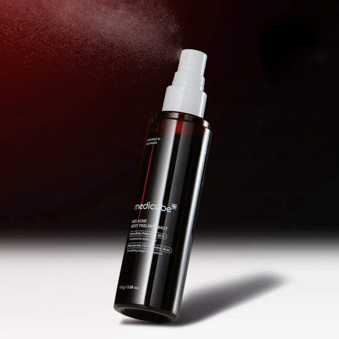 Spraying Medicube Red Body Peeling Shot on shoulder - 360 degree spray